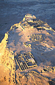 Aerial view of ruins of ancient palaces and fortifications on a mountain plateau, former Judean fortress, Masada, at the dead sea, Israel