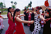 Women in flamenco dresses dancing on the street, Romeria de San Isidro, Nerja, Costa del Sol, Malaga province, Andalusia, Spain, Europe