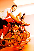 Spinning, Men and woman in gym on exercise bikes, Spinning, leos Sports Club Muenchen