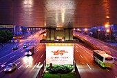 Illuminated advertisement and highway with cars in the evening, Shanghai, China, Asia