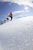 Young couple running through deep snow