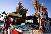Bedouins Ribe and Nedia standing next to their tent in the desert, Nefleyet, Tunesia