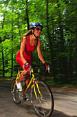 Woman cycling on road