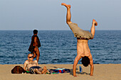 Young men on the beach, Playa Bogatell, Barcelona, Spain, Europe