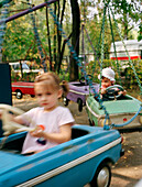 Children in merrygoround, Izmailovsky Park, Moscow, Russia