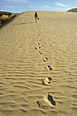A person and footprints on Te Paki sand dune, North Island, New Zealand, Oceania