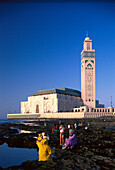 People at the reef and mosque Hassan II under blue sky, Casablanca, Morocco, Africa