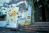 Pigeons flying around, man in front of Hindu temple, Gergetown, Penang, Malaysia, Asia