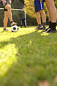 Young men preparing soccer ball for free kick