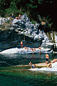 People enjoying a bath in the river, Valle di Maggia, Ticino, Switzerland