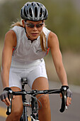 Close up of a woman on a racing bike, Apache Trail, Arizona, USA