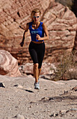 Woman jogging, running in Joshua Tree National Park, California, USA