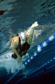 Woman training in a swimmimg pool, competitive swimming competition, Under water