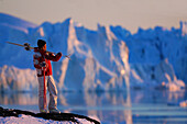 Woman carrying skis, admiring the view, Skiing, Ilulissat, Greenland