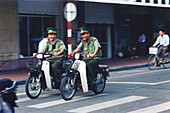 Policemen driving on a Moped, Hanoi, Vietnam