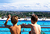 Two boys at open air pool Opelbad, Neroberg, view over Wiesbaden, Hesse, Germany, Europe