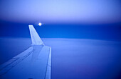 View at wing of an aircraft at moonrise