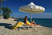 Woman sunbathing on the beach, Club Med, Jerba La Douce, Djerba, Tunesia
