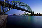 View below the Sydney Harbour Bridge across the harbour to the Opera House, Sydney, Australia