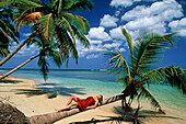 Lying woman, Palm beach, coconut palms, Dominican Republic, America