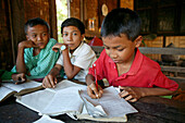 School children busy learning, Schulklasse, Dorfschule