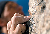 Hand of a climber at a rock face, Close-up