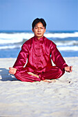 Young man doing Yoga on the beach, China Beach, Danang, Vietnam, Asia