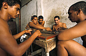 small group playing dominoes in heat of day, Cuba