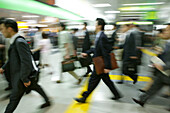 Business men crossing at rush hour, people in motion Tokyo, Japan