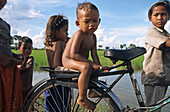 group of children and one bicycle, Cambodia, Asia