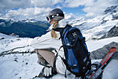 Girl sitting at a ski slop, Skiing Alps
