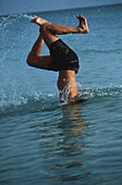 Young man diving into water