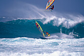 Two sailboarders in front of a wave, France, Europe
