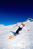 Young woman kiteboarding in snow, Lermoos, Lechtaler Alpen, Tyrol, Austria