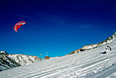 Man kiteboarding in snow, Lermoos, Lechtaler Alpen, Tyrol, Austria