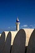 Fort and minaret under blue sky, Nizwa, Oman, Middle East, Asia