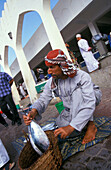 Salesman with fish at the market, Muscat, Oman, Middle East, Asia