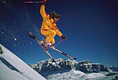 Skier jumping in mid air off a snow covered mountain, Sella Ronda, Dolomites, Italy