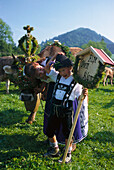 A woman and a boy wearing traditional costumes, a decorated cow at cattle drive, Oberstaufen, Allgaeu, Germany