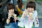 Teenagers eating ice cream, Harajuku, Tokyo, Japan