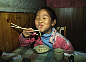 Girl sucking noodle, Taipei, Taiwan