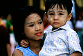 Mother and boy with Thanaka make up, , Rangoon, Myanmar Asia