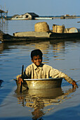 Tonle Sap lake, boy paddling in a tub, Siem Raep, Cambodia Asia