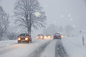 Cars in snow flurry on highway, Bavaria, Germany