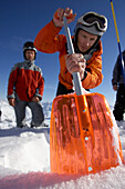 Mountain guide shoveling snow, checking danger of avalanches, Bavaria, Germany