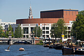Boats, Amstel, Stopera Theater, , People in boat on amstel passing Stopera, the muziektheater of Amsterdam, Amsterdam, Holland, Netherlands