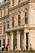 People walking along Belvedere Palace, Vienna, Austria