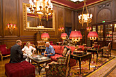 People sitting inside the lobby of Hotel Sacher, Vienna, Austria