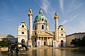 View over the Karlsplatz with basin and plastic Hill Arches to the Karlskirche, Vienna, Austria