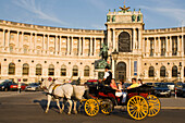 Fiaker passsing Neue Hofburg, Vienna, Austria